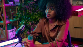 Young African woman, blogger taking part in online podcast show, giving interview, discussing interesting lifestyle topics