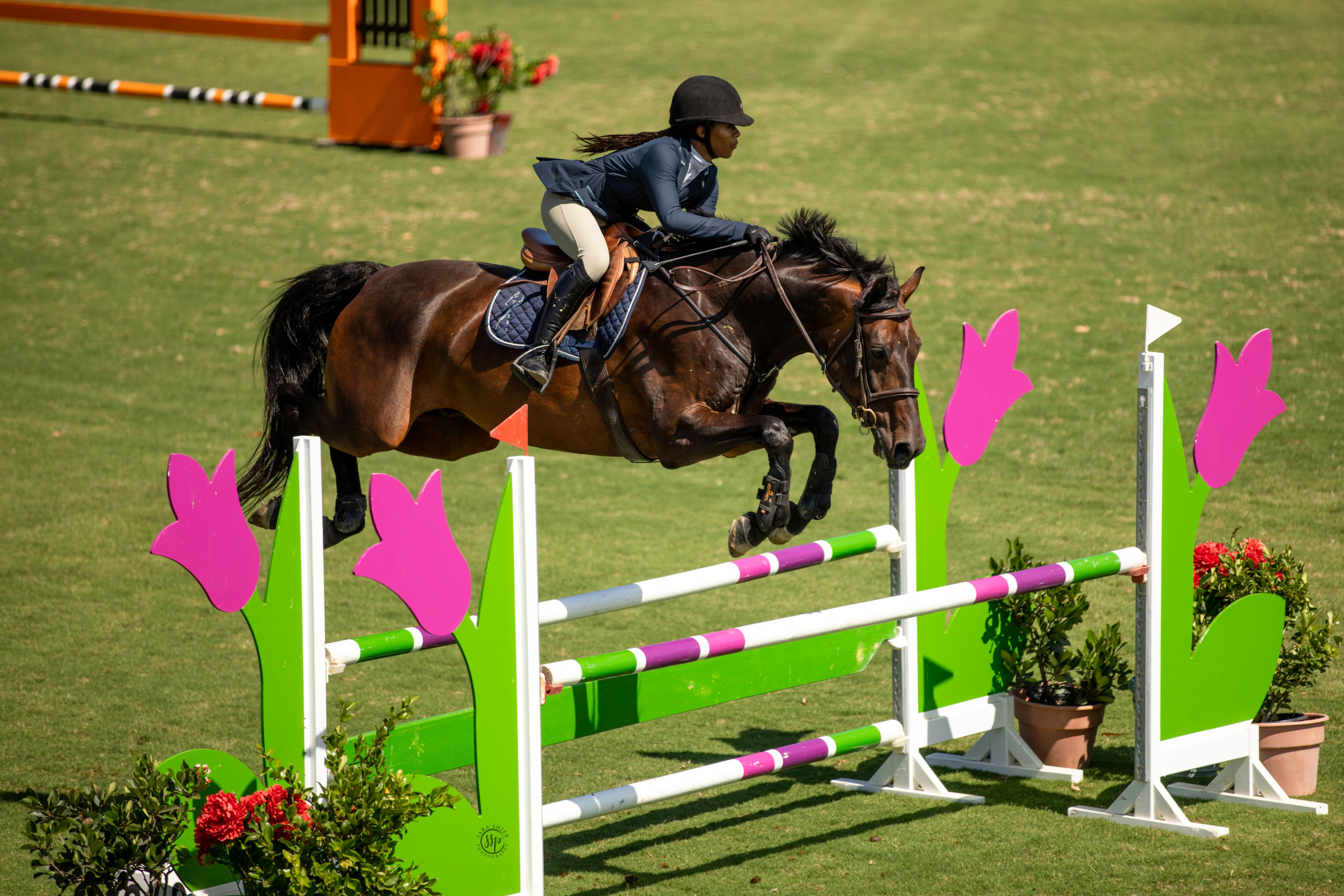 Zoie Brogdon and horse, jumping during competition.