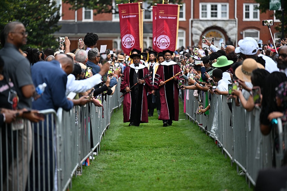 Illya Davis and Dr. Brian Lawrence leading the processional for the 141st Morehouse College Commencement Ceremony at Morehouse College, 2025 in Atlanta, Georgia. Image: Paras Griffin/Getty Images.